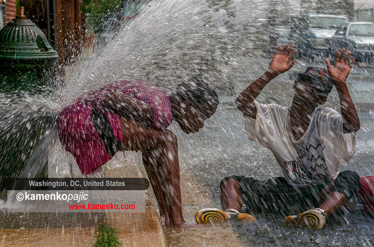 Children play on firehydrant