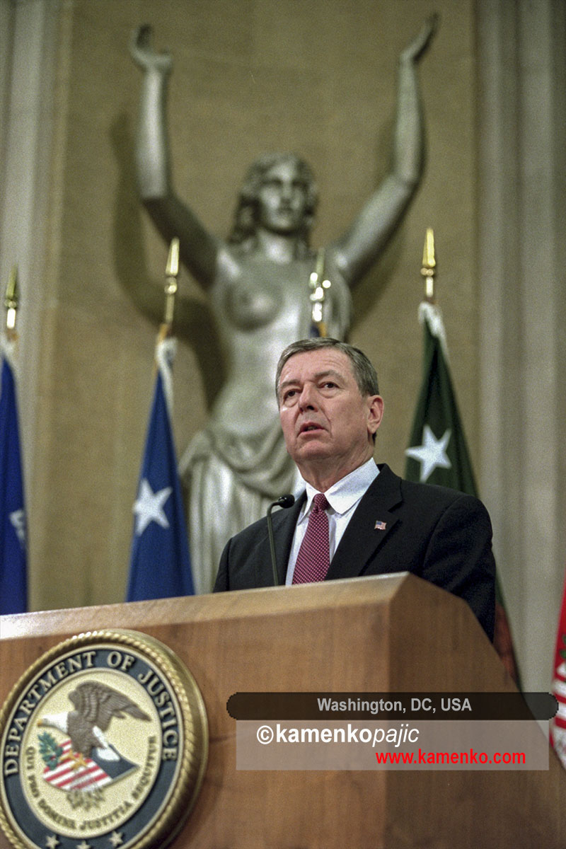 With the Spirit of Justice statue behind him, US Attorney General John Ashcroft addresses employees at the Justice Department in Washington on November 8, 2001