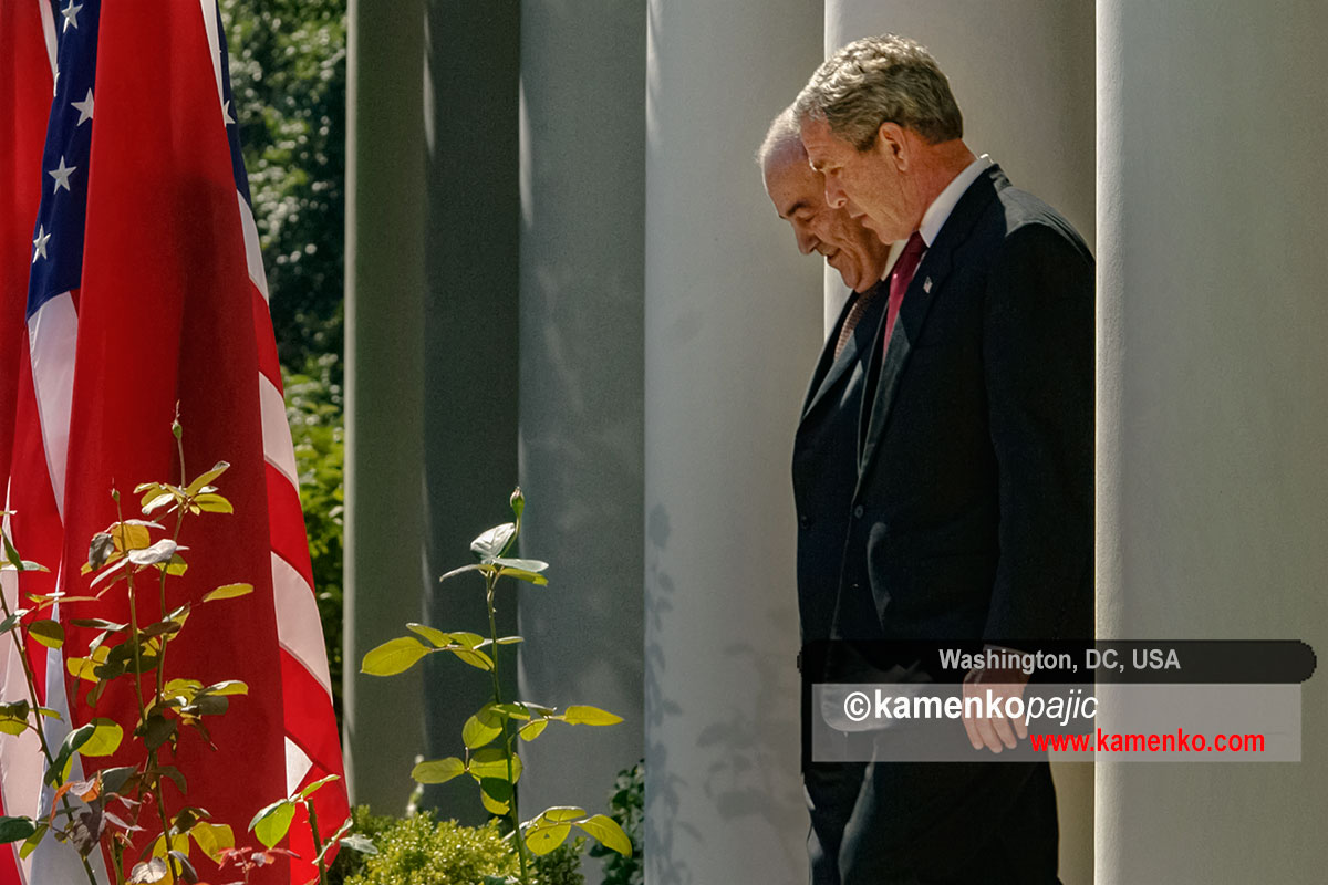 U.S. President George W. Bush and Iraq's interim Prime Minister Ayad Allawi walk into the White House Rose Garde