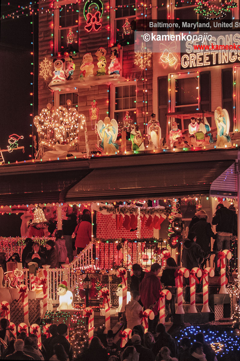 People stream in during the early evening to admire highly decorated front porches