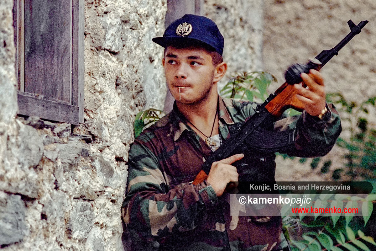 Bosnian Serb soldier throws a hand grenade