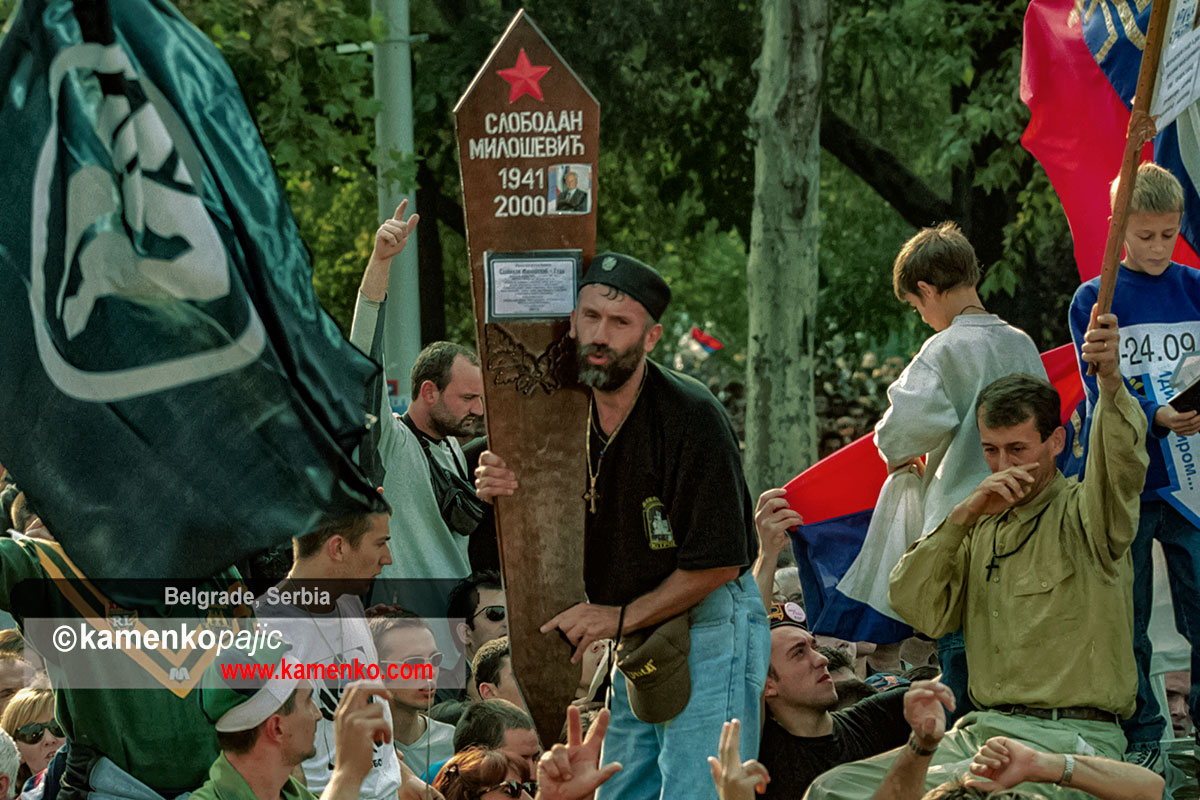 A protester carrying a mock tombstone for Slobodan Milosevic