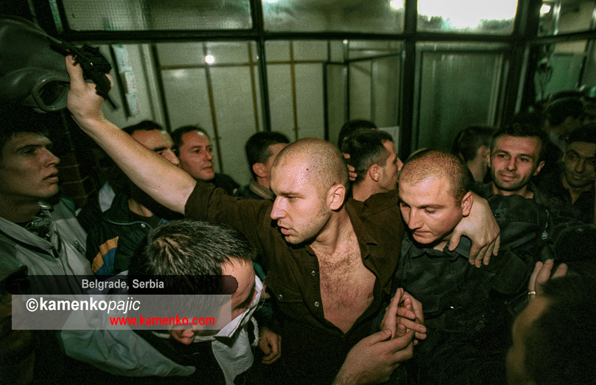 Police officers  surrendering their police station to protesters