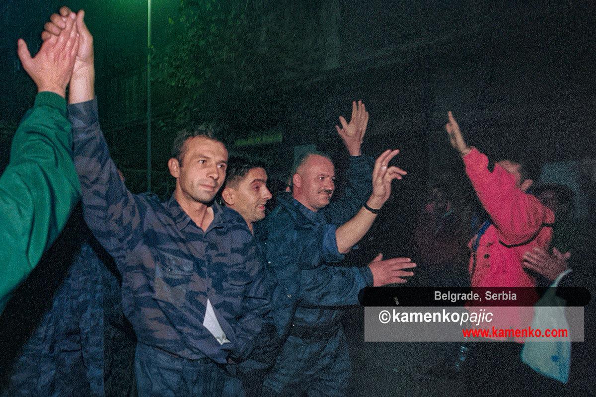 Police officers greeted by bystabders after surrendering police station